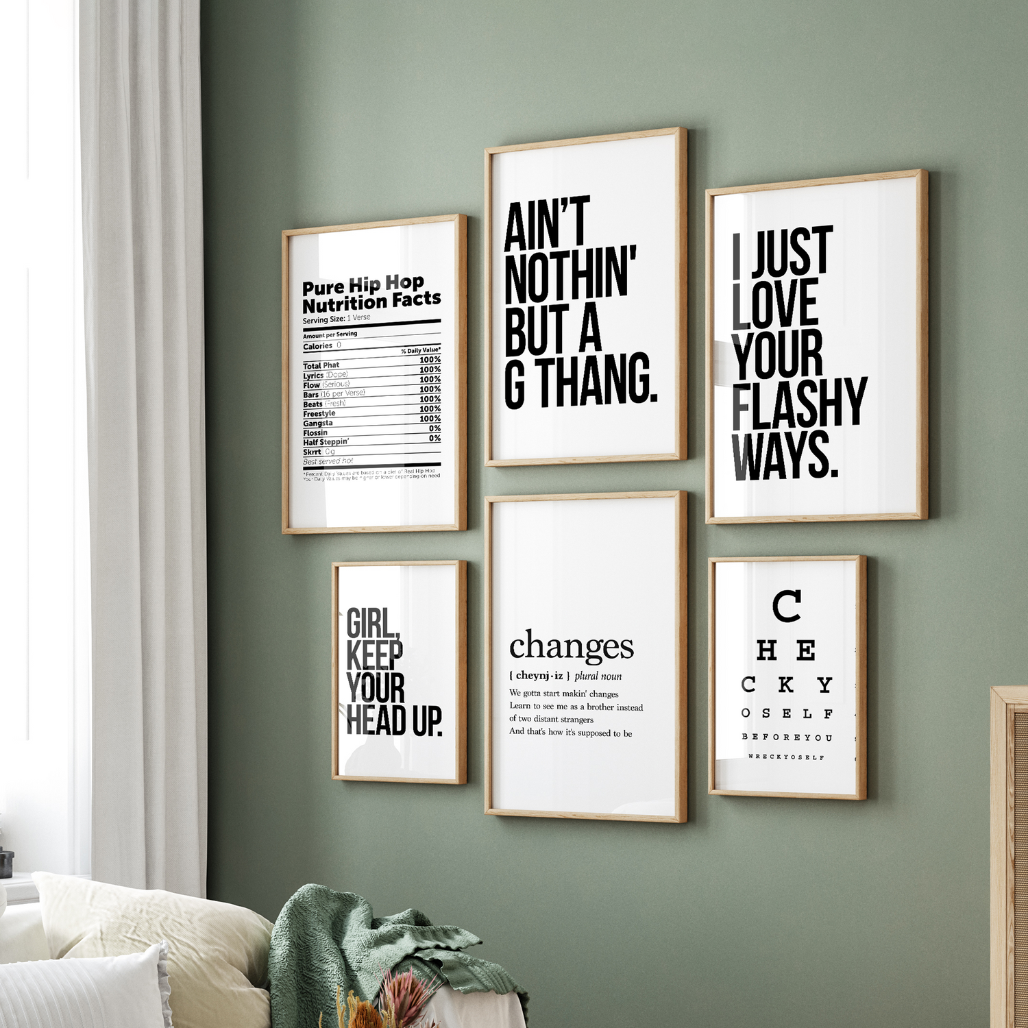 Framed, typographic hip-hop quotes hanging on a green living room wall