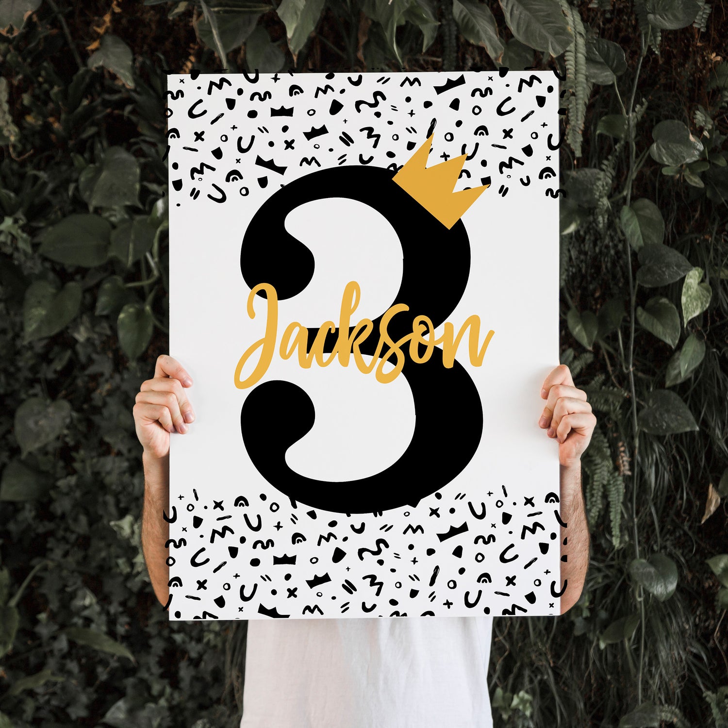 Person holding up a large welcome sign with a number three and crown on it