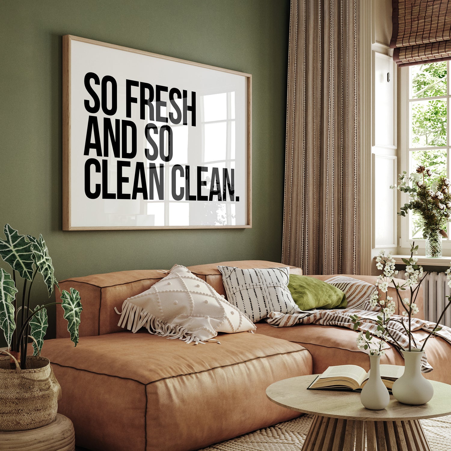 A framed, hip hop-themed typographic poster hanging on a green living room wall