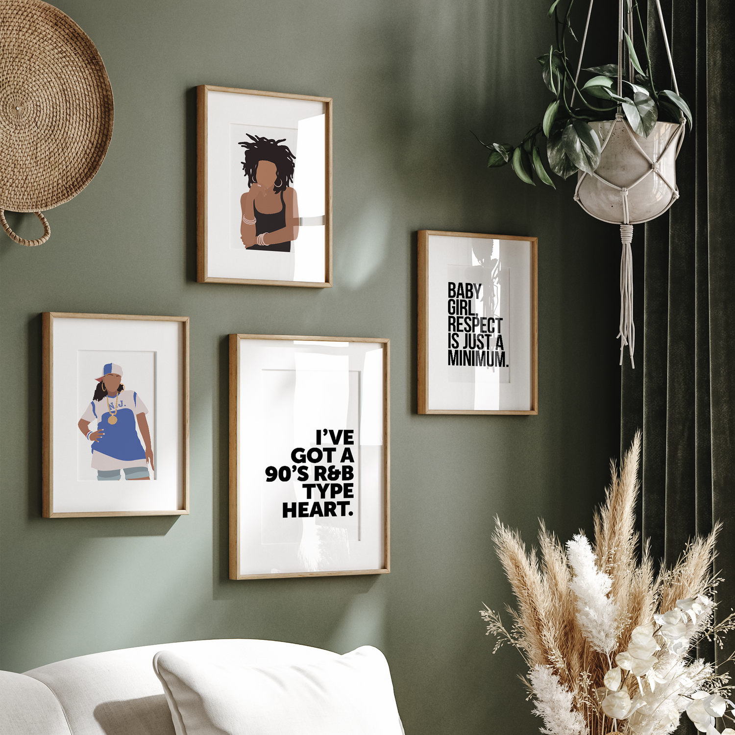 Set of hip hop-inspired posters in wooden frames hanging on a green living room wall