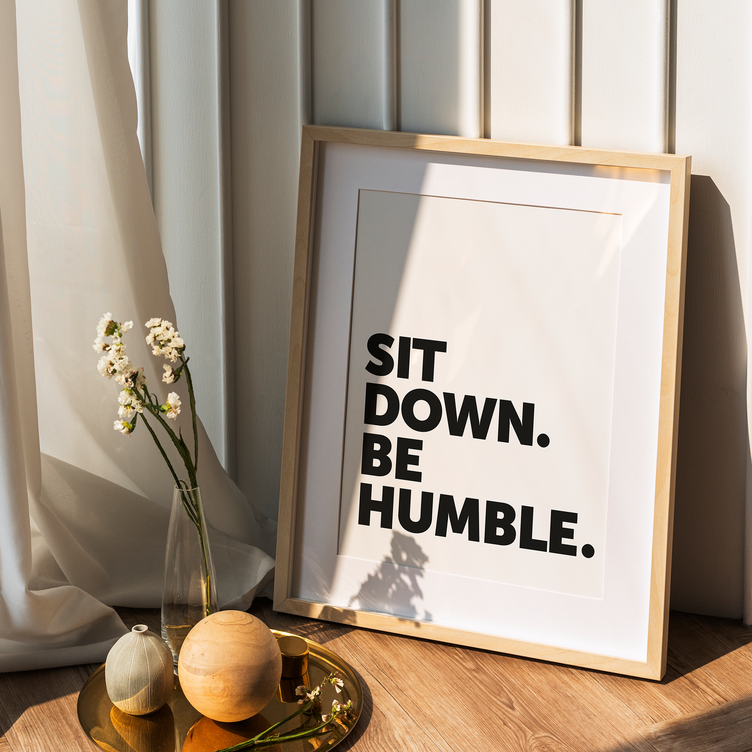 A wooden frame with a hip hop-themed typographic poster leaning on a wall
