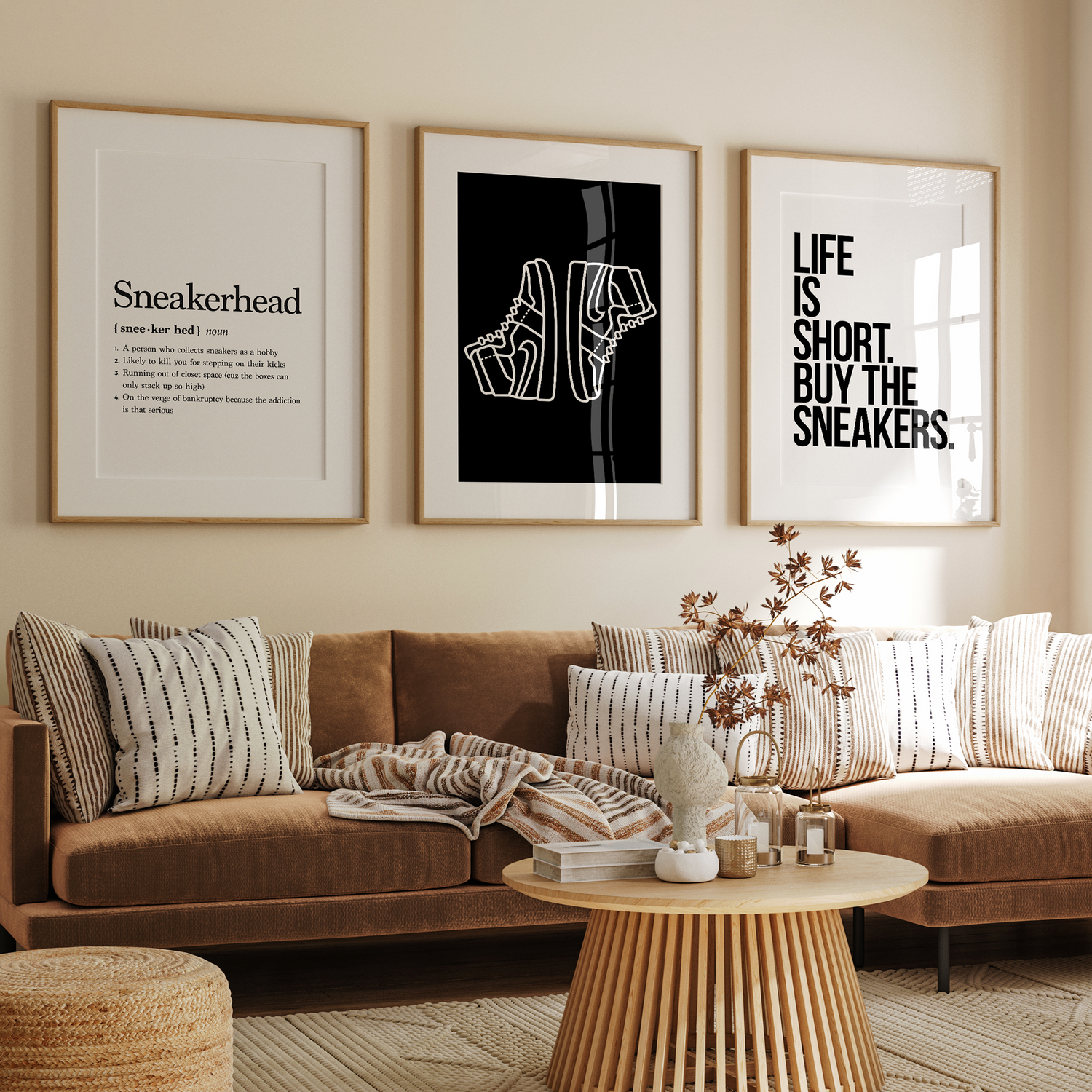 Set of sneaker-themed posters in wooden frames hanging on a living room wall above sofa