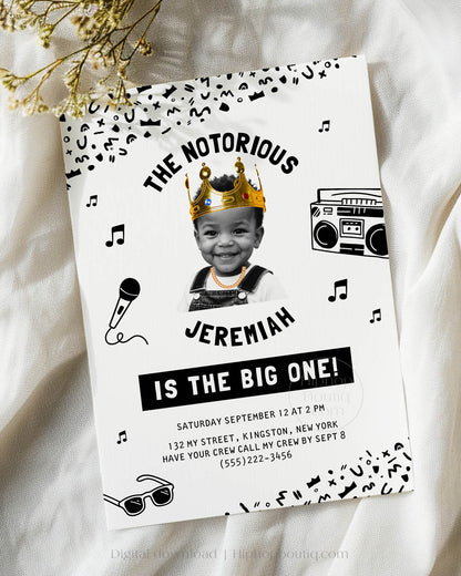 Hip-hop themed, printed birthday invitation card. The card features an editable 'Notorious One' design with a black and white squiggly pattern, and an image of a happy child wearing a crown and a gold chain.