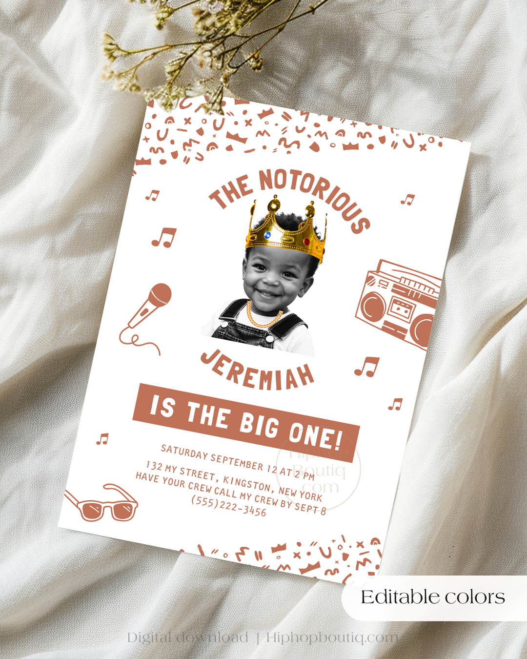 Hip-hop themed, printed birthday invitation card. The card features an editable 'Notorious One' design with a black and white squiggly pattern, and an image of a happy child wearing a crown and a gold chain. Text reads: Editable colors.